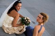 bride and maid of honor on church steps