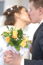 young married couple first kiss as man and wife